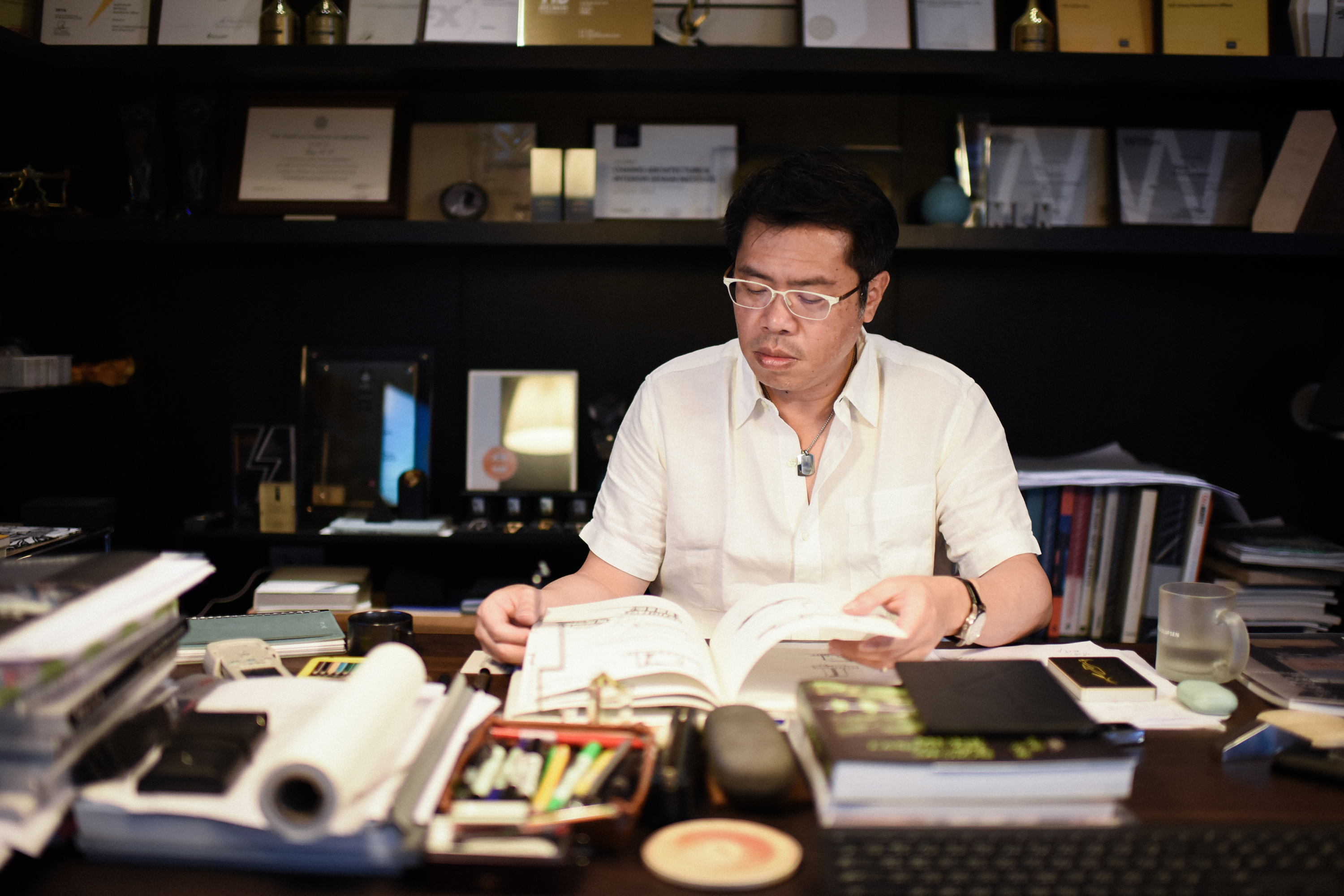 A Taiwanese architect named Keng-Fu Lo sketches car garages in his office.