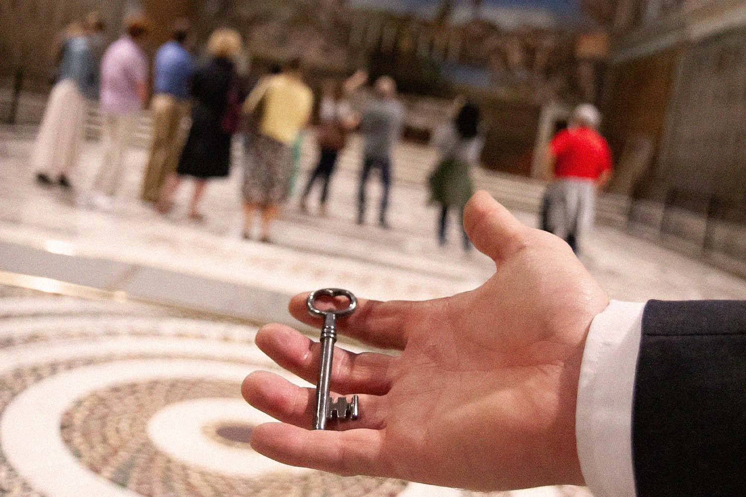 Hand holding the key to the Sistine Chapel