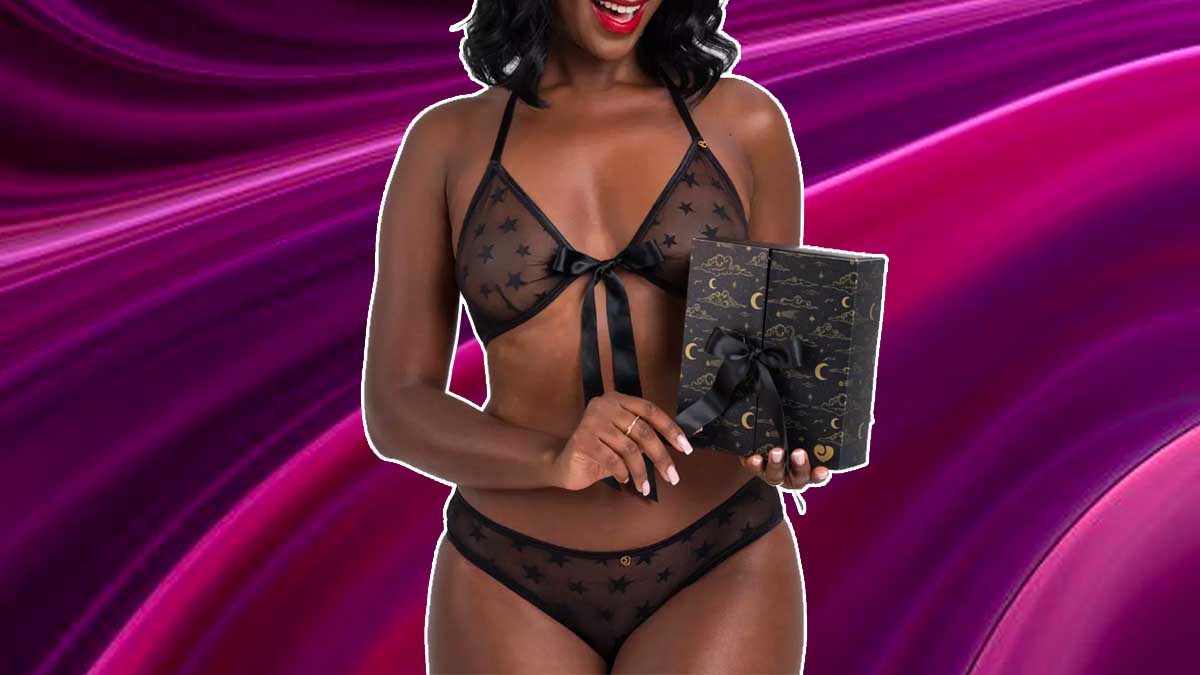A woman in lingerie holding Lovehoney's lingerie advent calendar