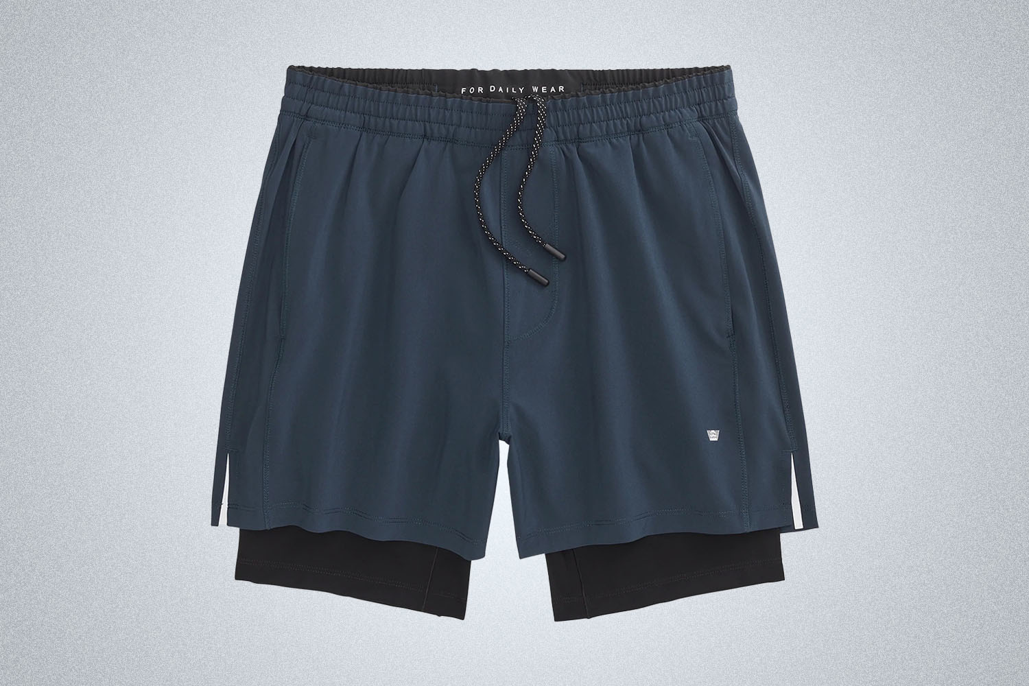 a pair of blue and black shorts from Mac Weldon on a grey background