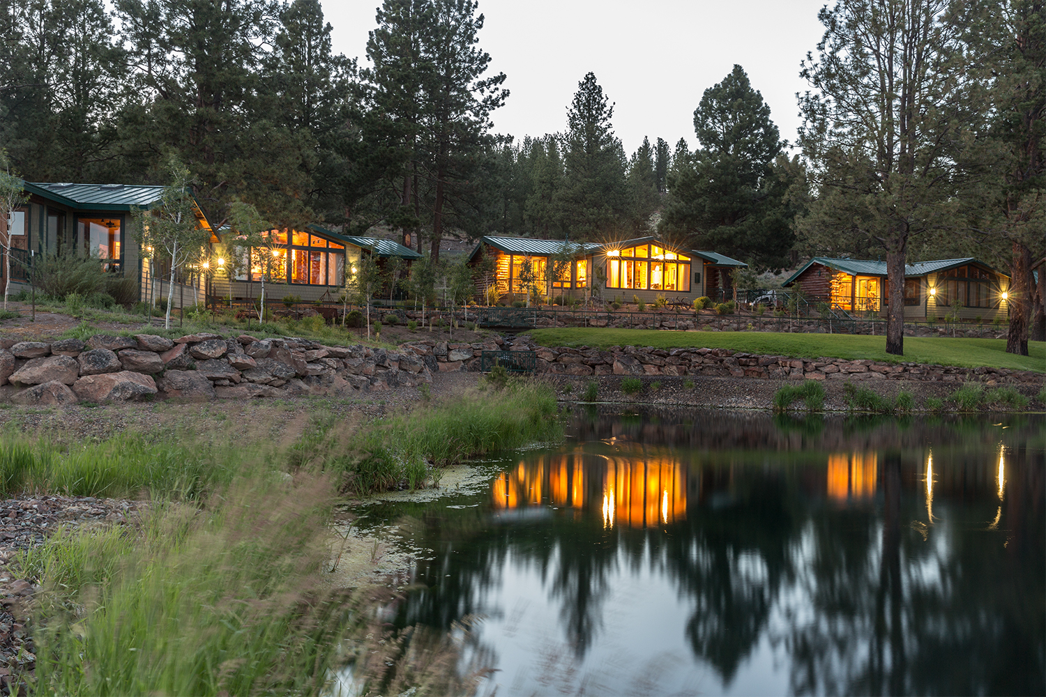 Lighted rooms on the water at Silvies Valley Ranch, one of the best luxury ranch resorts in the U.S.