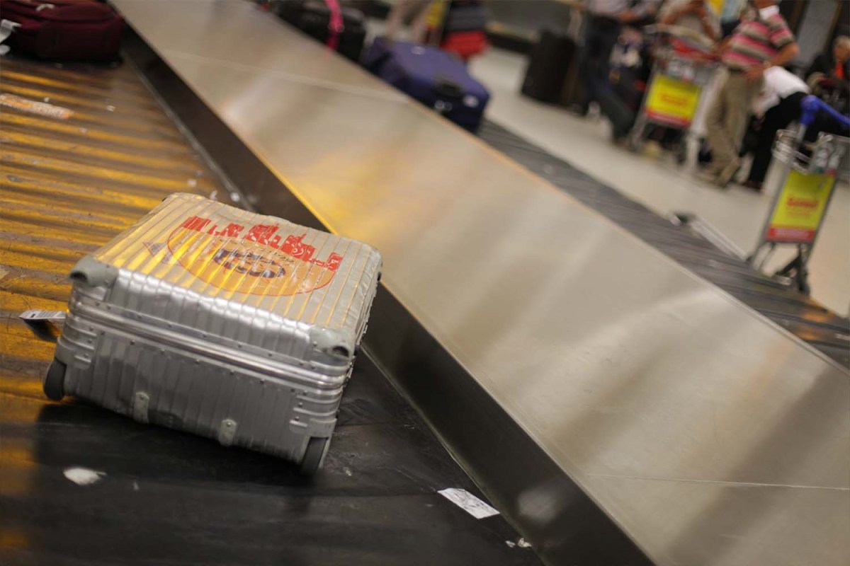 Aluminum suitcase on a baggage carousel