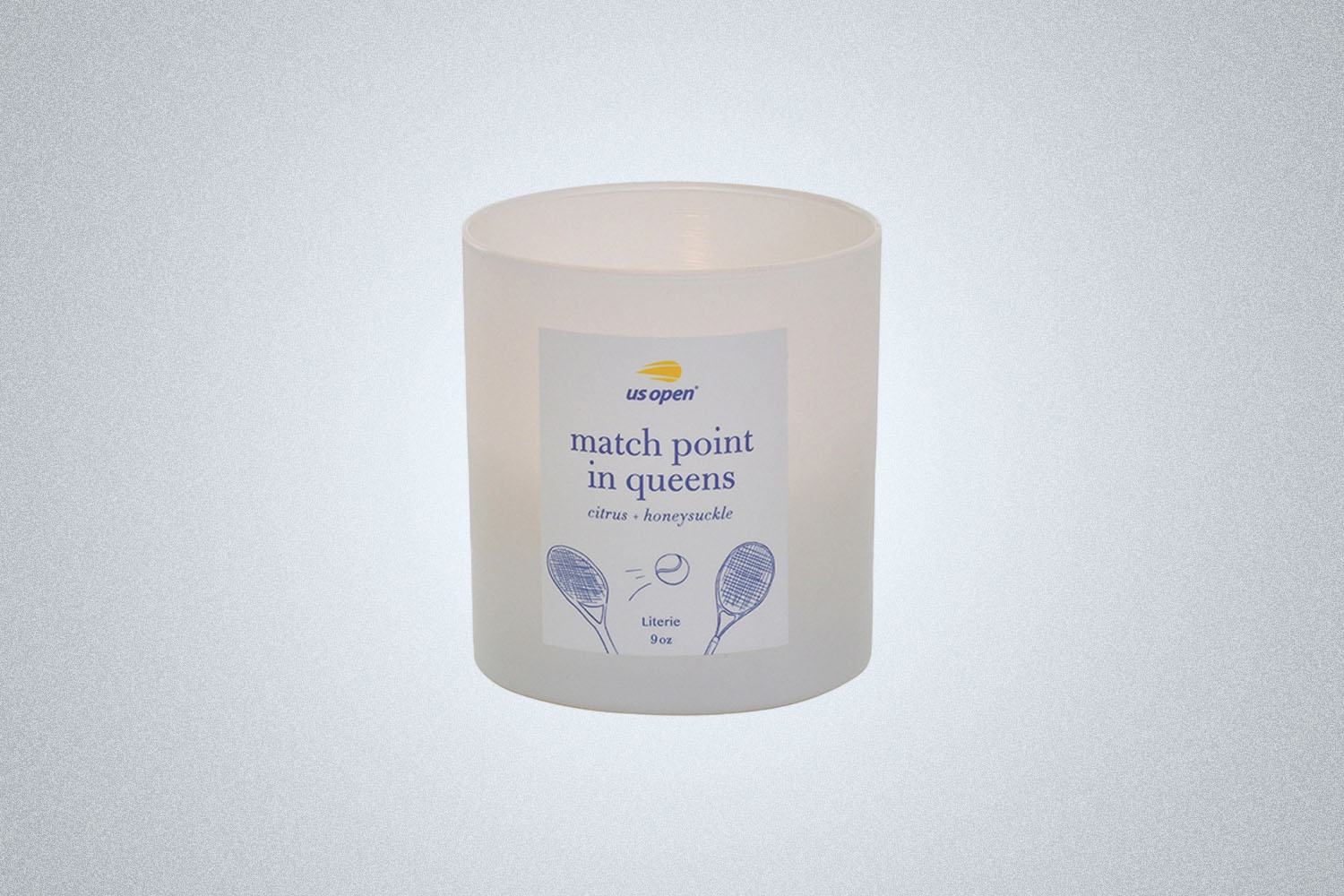 a white candle with US Open label on a grey background