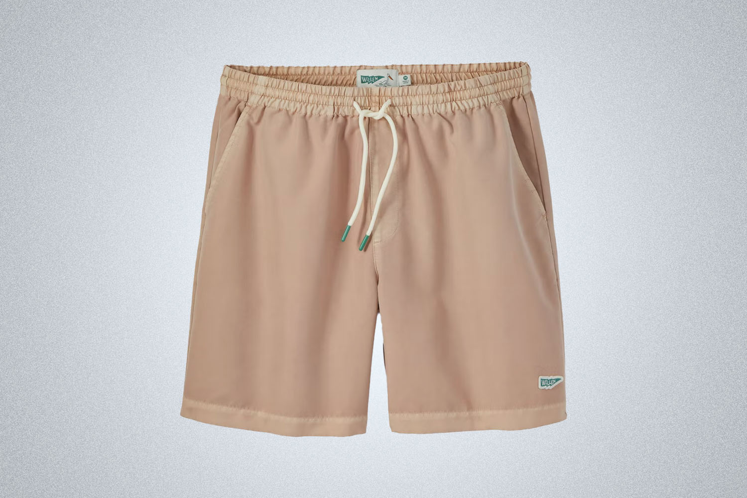 A pair of dusty pink swim trunks from Wellen on a grey background