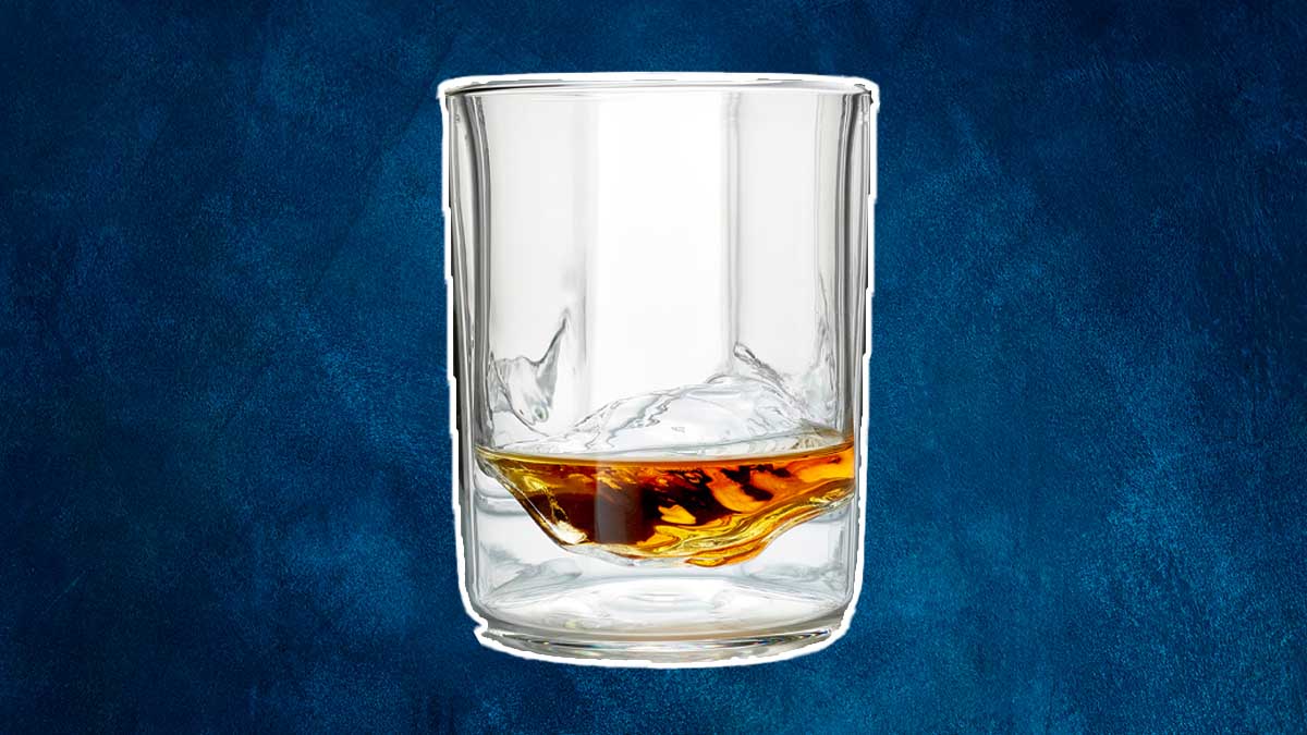 A Whiskey Peaks glass with booze in it. The glassware is on sale at Huckberry.