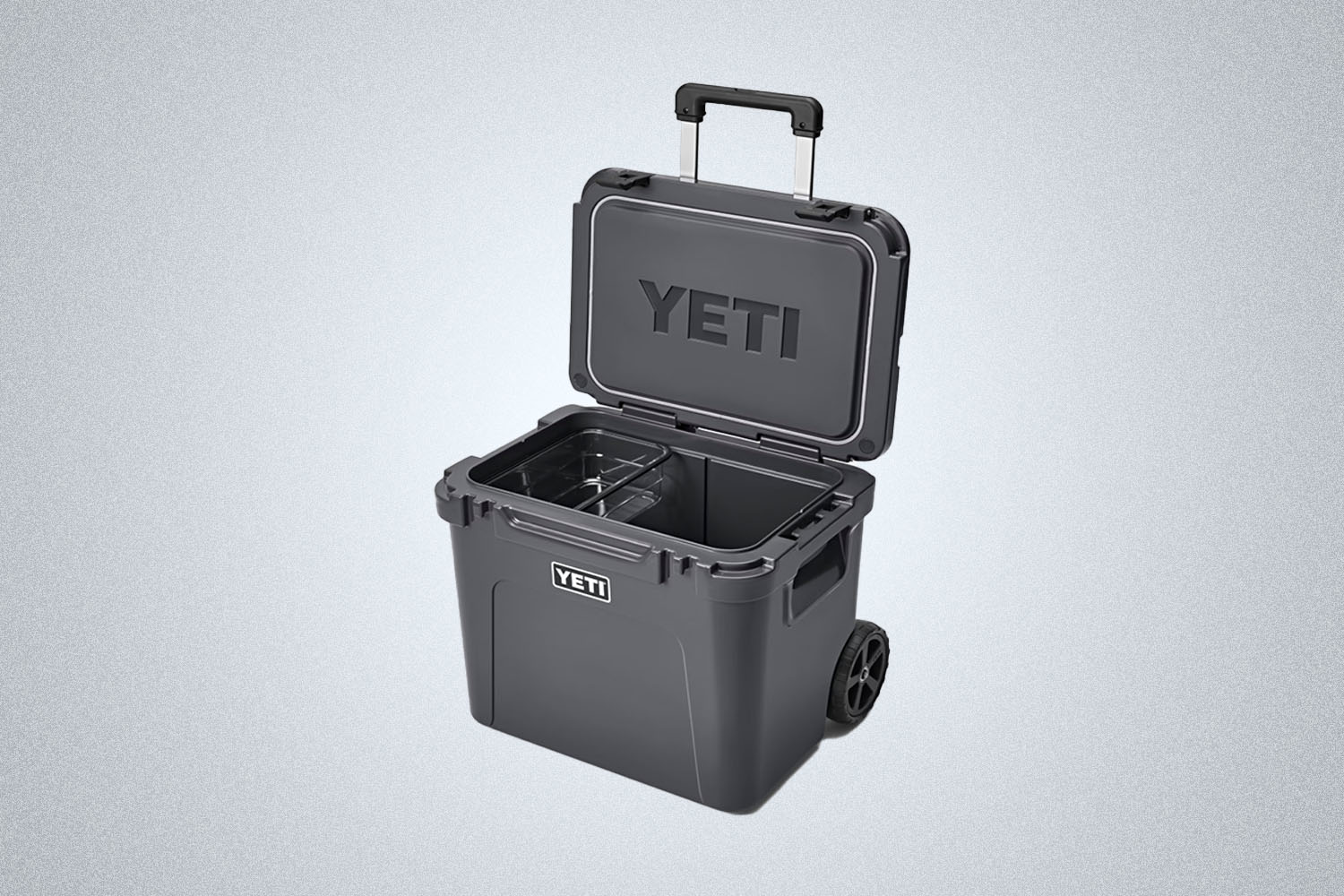 a grey Yeti Roadie rolling cooler on a grey background
