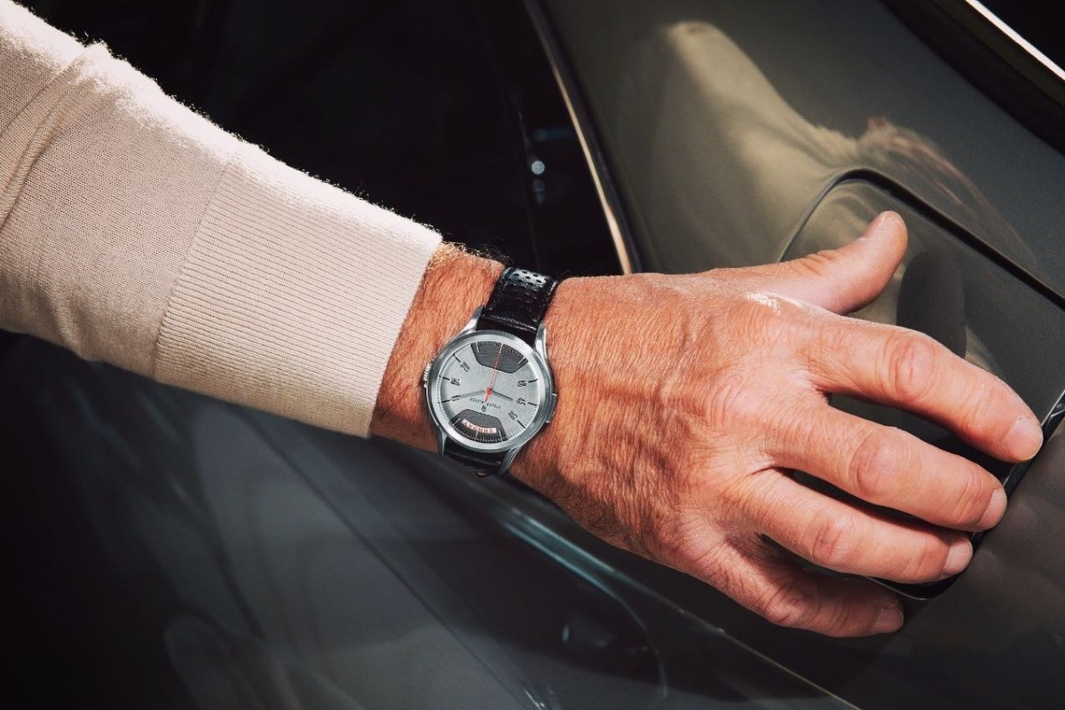 A watch from Atelier Jalaper, with a dial made from the hood of a DB5, on a man's wrist