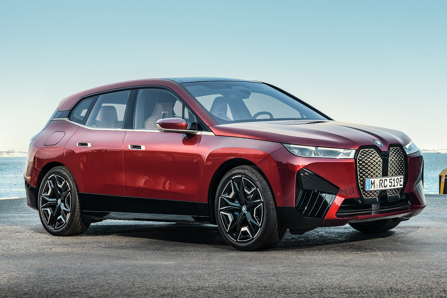The BMW iX xDrive50 electric SUV in red