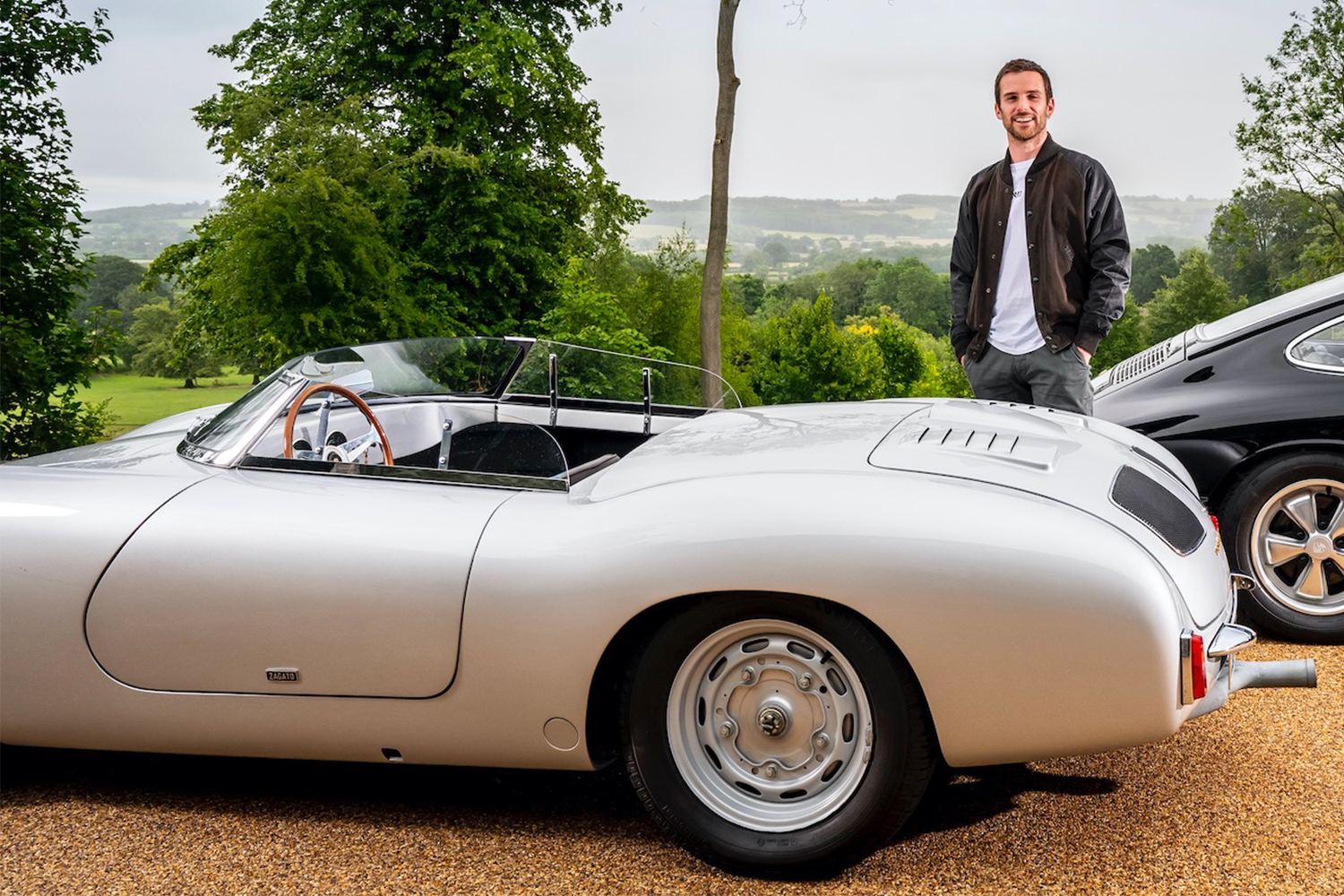 Coldplay bassist Guy Berryman standing next to a rare 356 Zagato, a continuation car based off a 1958 one-off racer