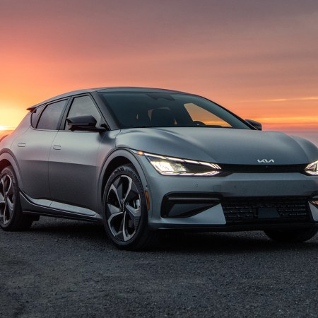 The 2022 Kia EV6, an electric SUV, sitting in front of a sunset