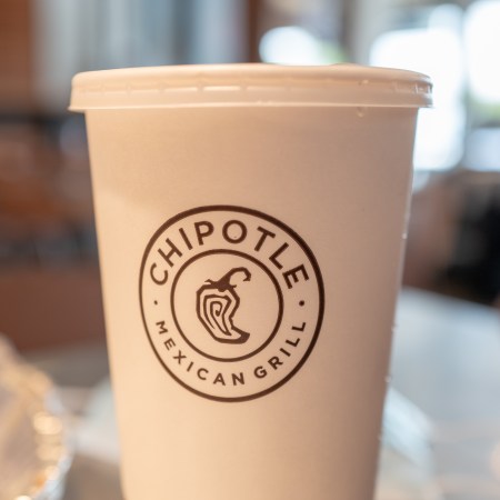 A Chipotle cup resting on a table.