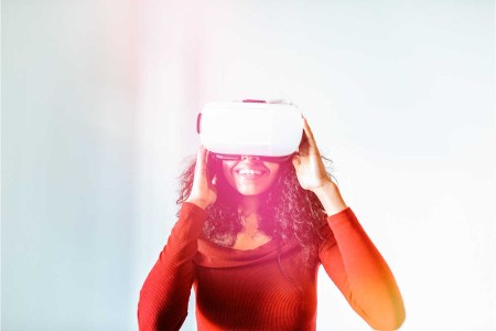 Woman with virtual reality glasses. A new McKinsey study suggests users may spend up to 5 hours per day in the metaverse.