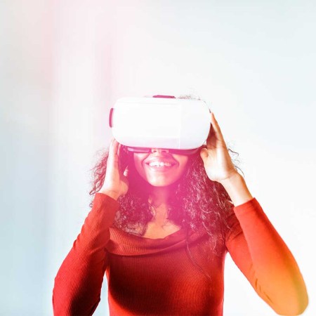 Woman with virtual reality glasses. A new McKinsey study suggests users may spend up to 5 hours per day in the metaverse.
