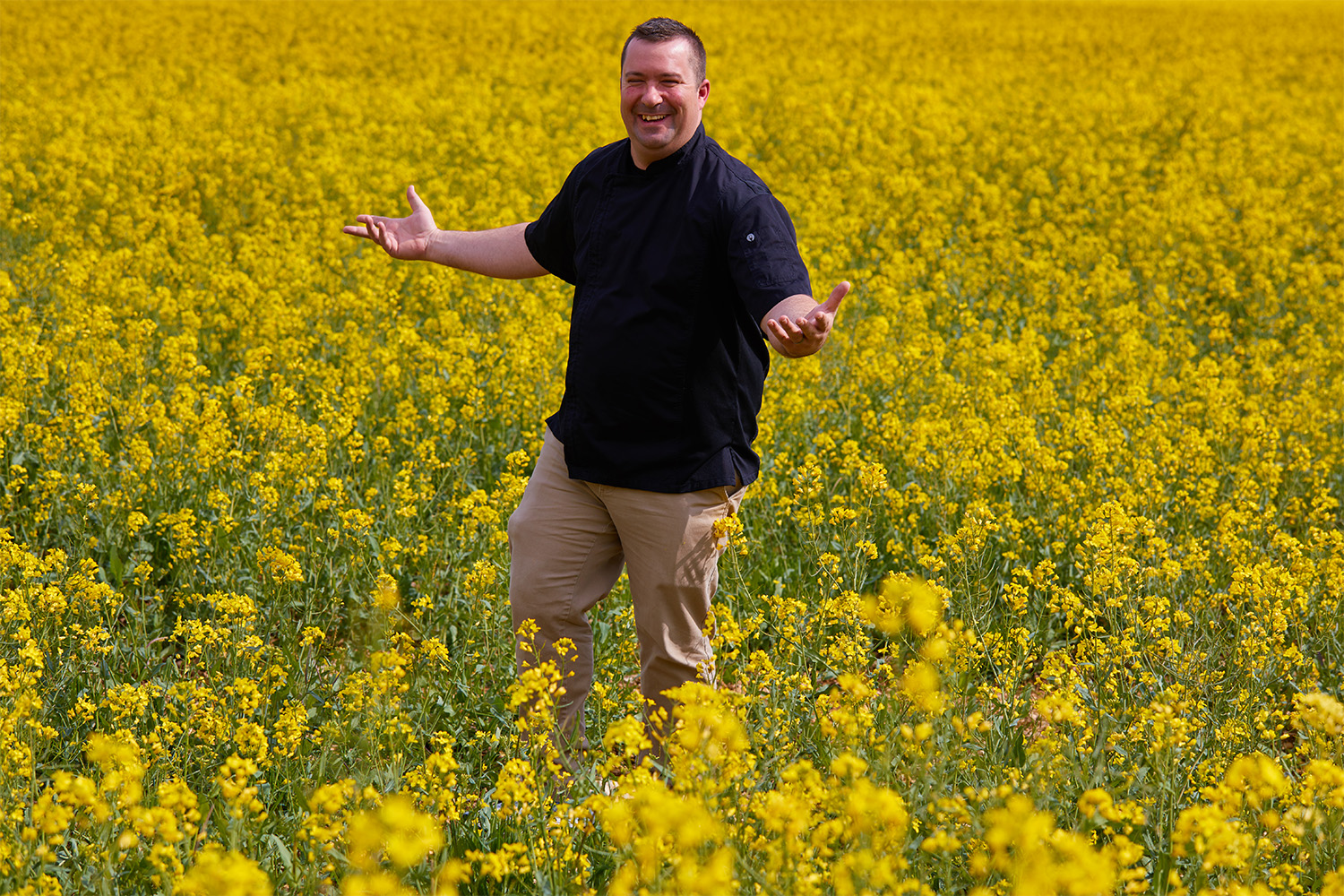 Chef Brandon in a mustard field