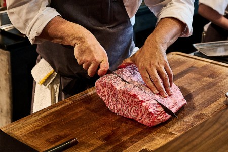 Chef Dustin Falcon of Niku Steakhouse in San Francisco slices through wagyu steak