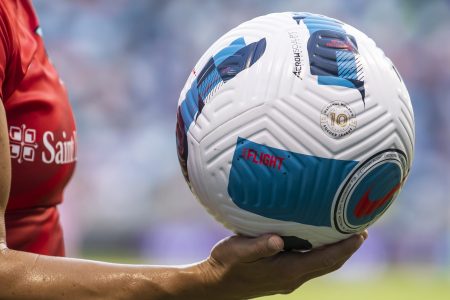 The NWSL-branded 10th anniversary match ball is carried by a player.