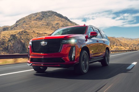 The 2023 Cadillac Escalade-V, which our automotive editor reviewed, driving down the road