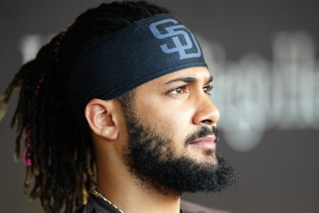 Fernando Tatis Jr. of the San Diego Padres watches warm-ups from the dugout.