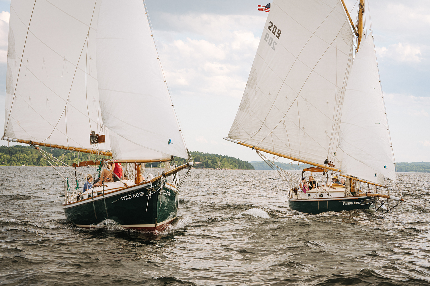 The two sloop boats available from Whistling Man Schooner out of Burlington, Vermont, the Friend Ship and White Rose, sailing on Lake Champlain