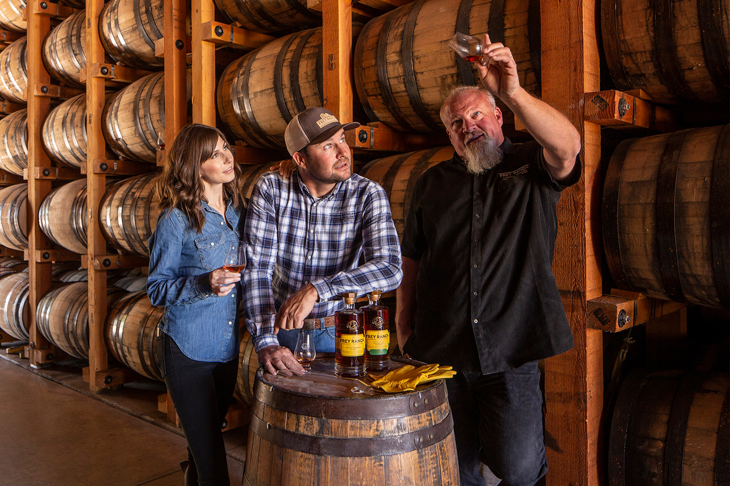 Ashley Frey, Colby Frey and distiller Russell Wedlake of the Frey Ranch distillery in a barrel room