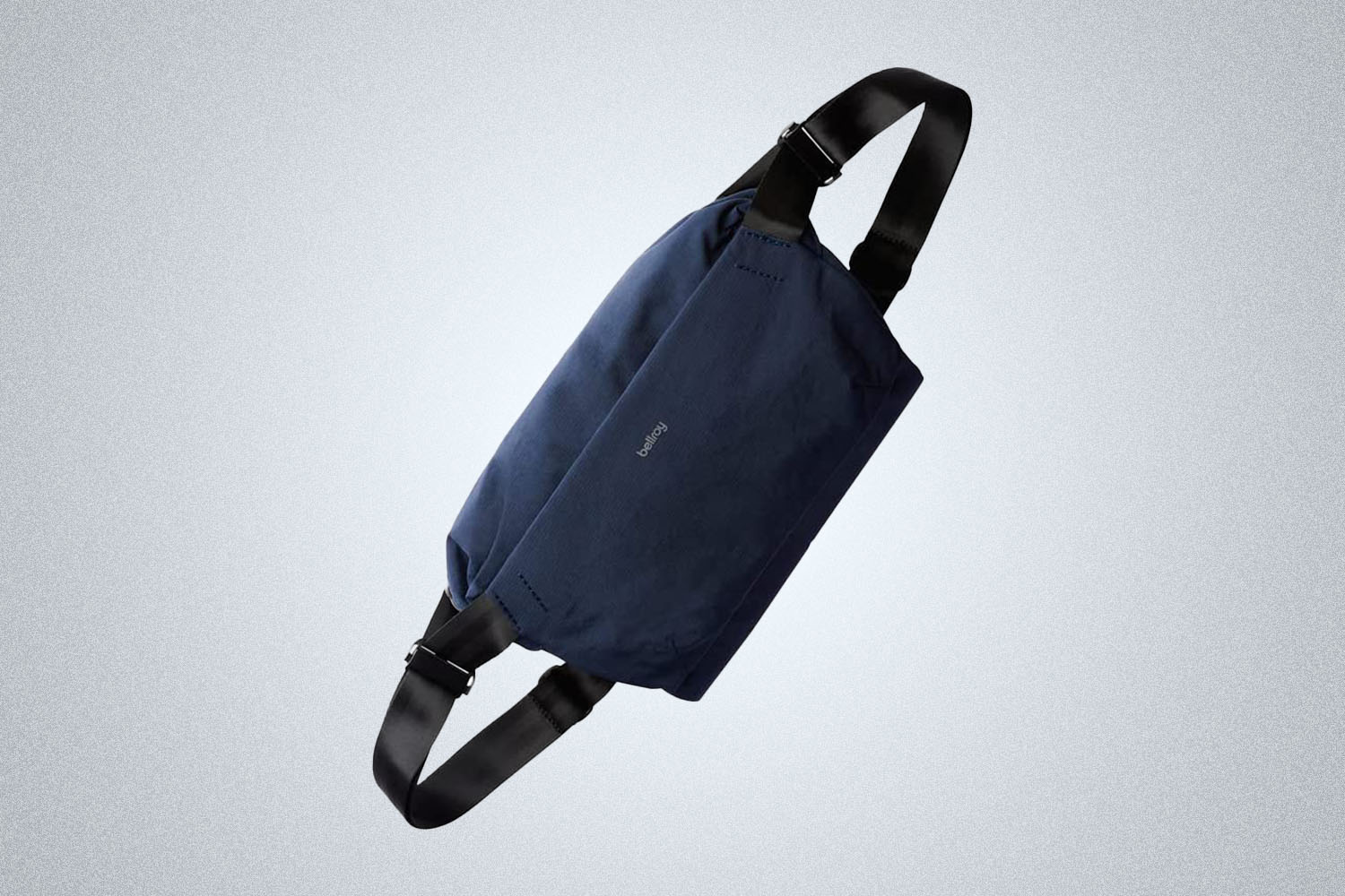A Bellroy Sling bag on a gray background