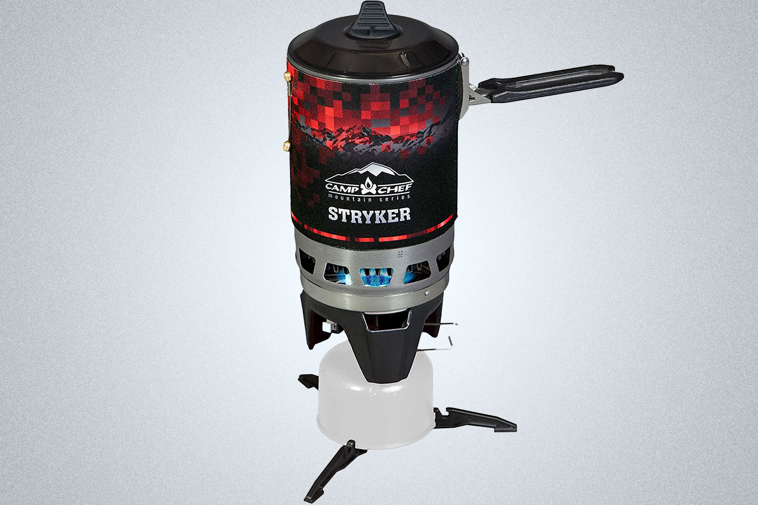 A Camp Chef Stryker 100 Stove on a gray background