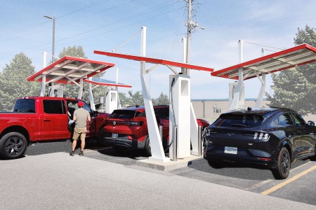 A Ford F-150 Lightning, Volkswagen ID.4 and Ford Mustang Mach-E charging at the Electrify Canada station in Kingston, Ontario