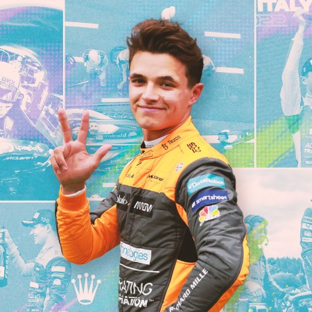 The 22-year-old British-Belgian Formula 1 driver Lando Norris waving in his racing suit in front of photos of the 2022 F1 season
