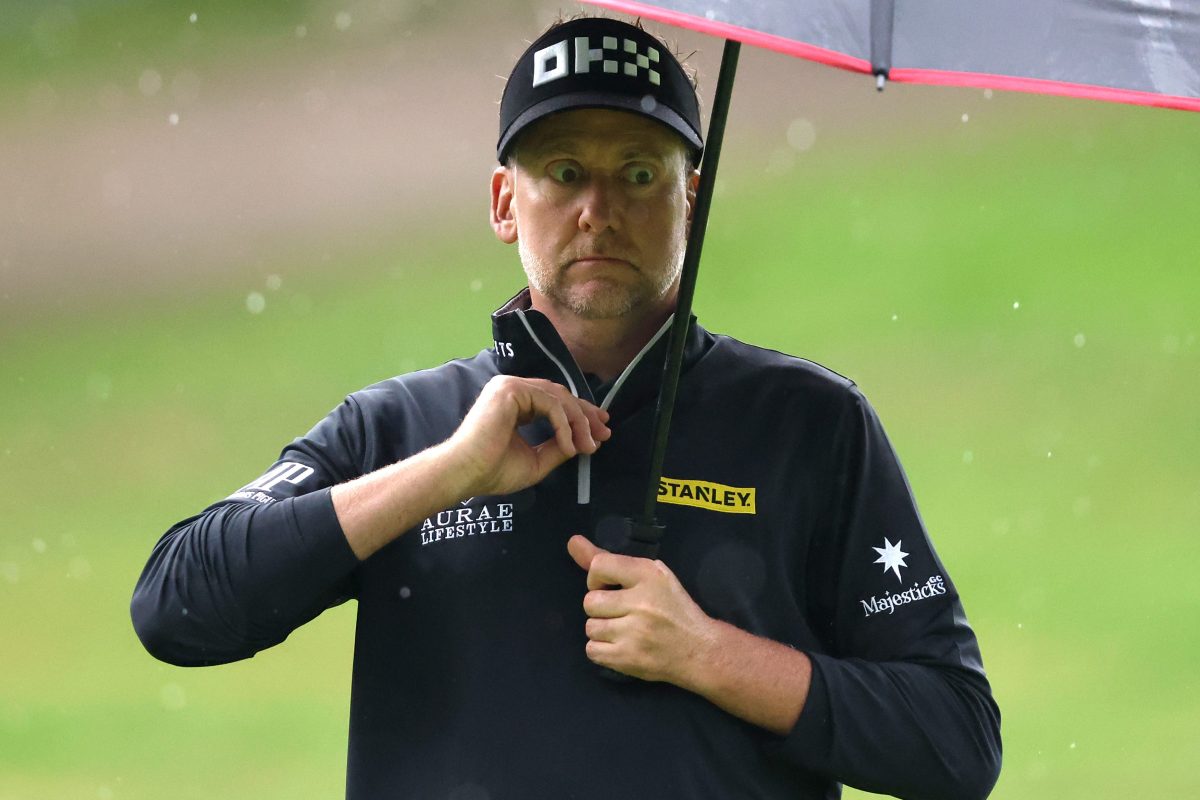 Ian Poulter under an umbrella during Day One of the BMW PGA Championship wearing a logo for his LIV Golf team the Majesticks on his sleeve