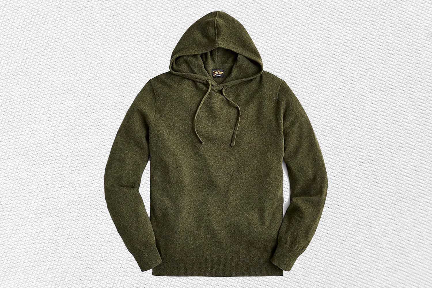 a green cashmere hoodie from J.Crew on a textured white background