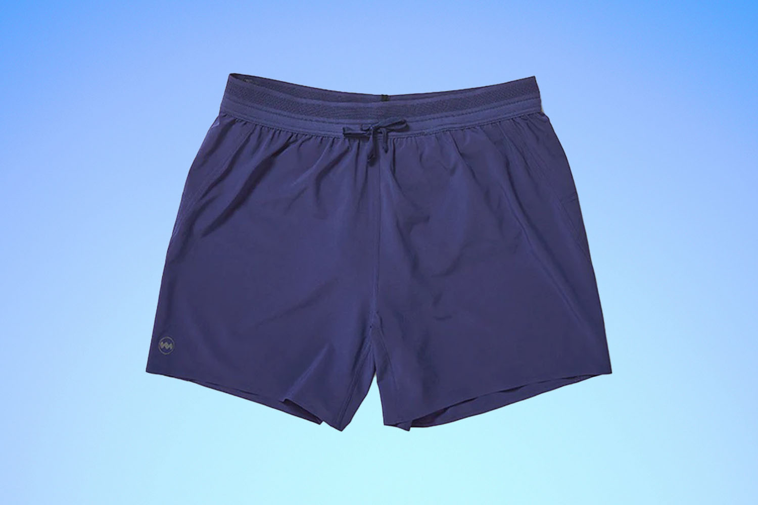 a pair of blue running shorts from Janji on a blue gradient background