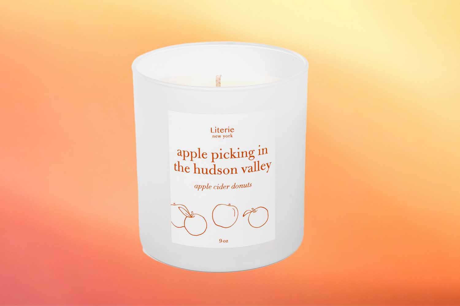 Literie apple picking in the hudson valley candle, one of the best fall candles for 2022 on an orange background