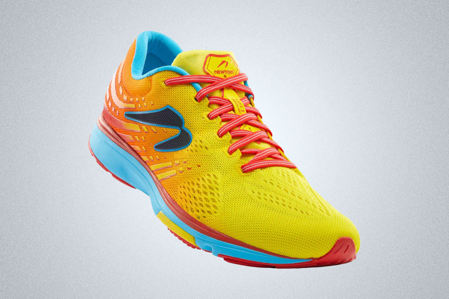 a yellow, orange and blue cushioned running shoe from Newton on a grey background
