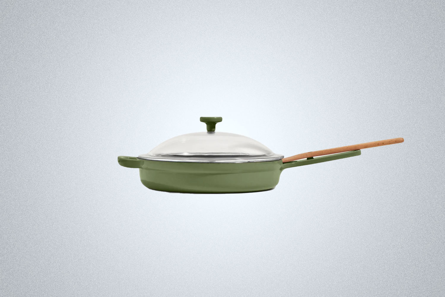 The Our Place Cast Iron Pan in green on a gray background