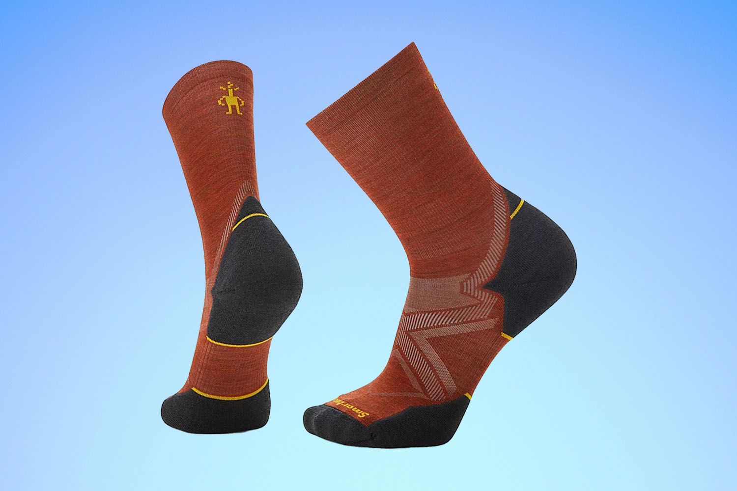 a pair of red and grey Smartwool running socks on a blue gradient background