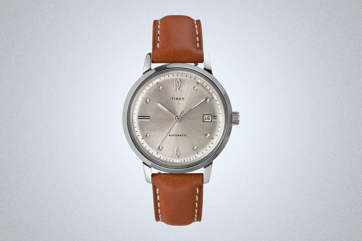 a bron leather Timex watch from Todd Snyder on a grey background