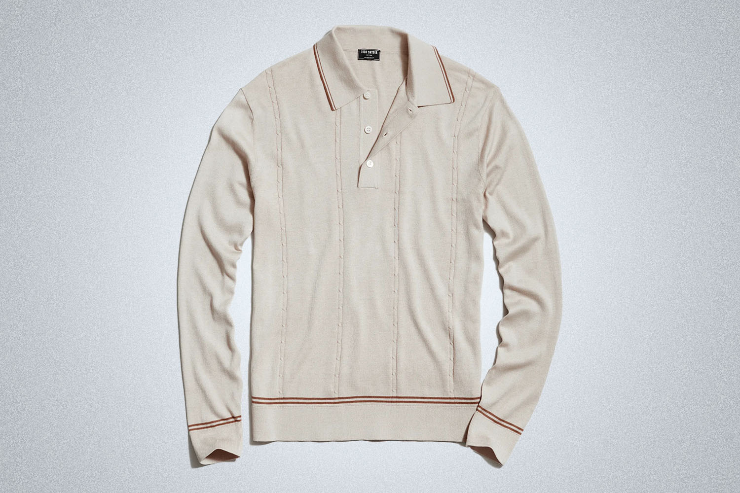 a cream tipped polo from Todd Snyder on a grey background