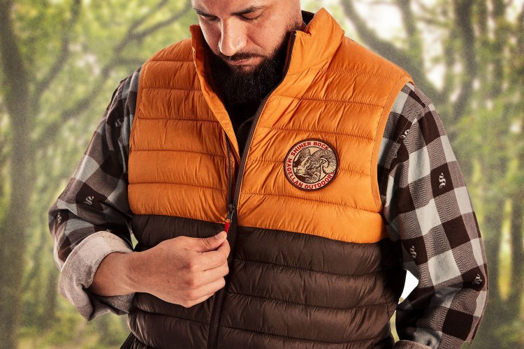A man wearing a Shiner Beer vest from the new Shiner x Magellan Outdoors collection