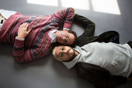 Max Kakacek and Julien Ehrlich of the band Whitney lying on the ground