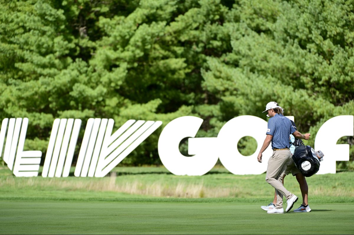 PGA Tour defector Cameron Smith seen prior to the LIV Golf Invitational in Boston, walking in front of a huge LIV Golf sign