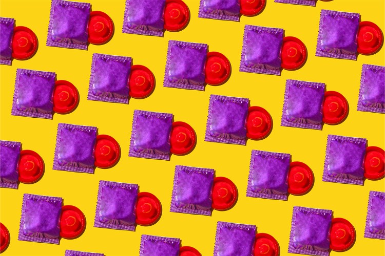 red condoms in purple packaging on a yellow background