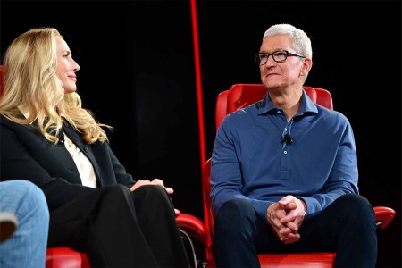 Laurene Powell Jobs and Chief Executive Officer of Apple Tim Cook speak onstage during Vox Media's 2022 Code Conference