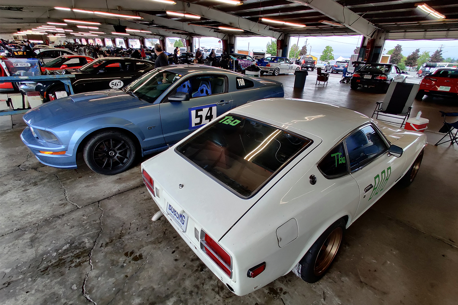 My 1978 Datsun 280Z next to my father's 2005 Ford Mustang GT in the garage at Watkins Glen International