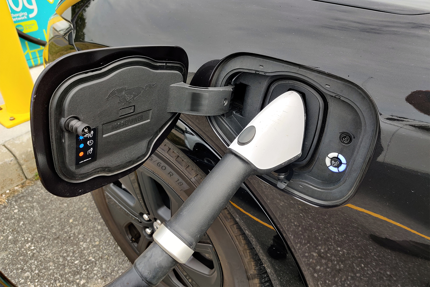 An EV charger plugged into a Ford Mustang Mach-E SUV that I drove on a road trip
