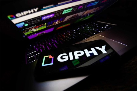Giphy logo displayed on a phone screen and Giphy website displayed on a laptop screen are seen in this illustration photo taken in Krakow, Poland on November 29, 2021. The gif search engine is using a less than flattering self assessment to prevent a sale from being blocked to Meta.