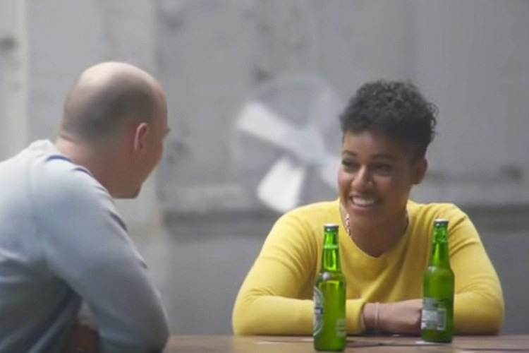 A screenshot from Heineken's 2017 ad campaign "Open Your World" featuring partisan opposites completing chores and talking to each other
