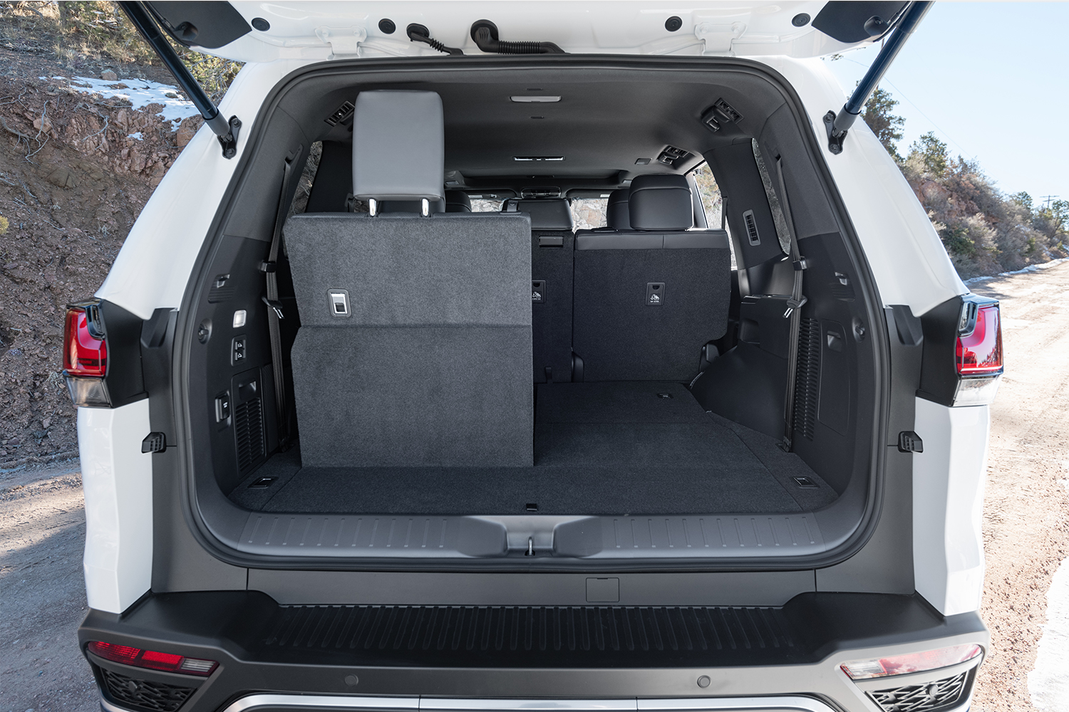 A view of the 2022 Lexus LX 600 from the rear looking into the back where you can see the seats and storage 