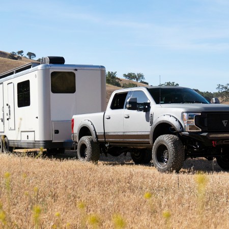 A pickup truck towing the 2023 Living Vehicle. We spoke with founder Matthew Hofmann about the luxury travel trailer.