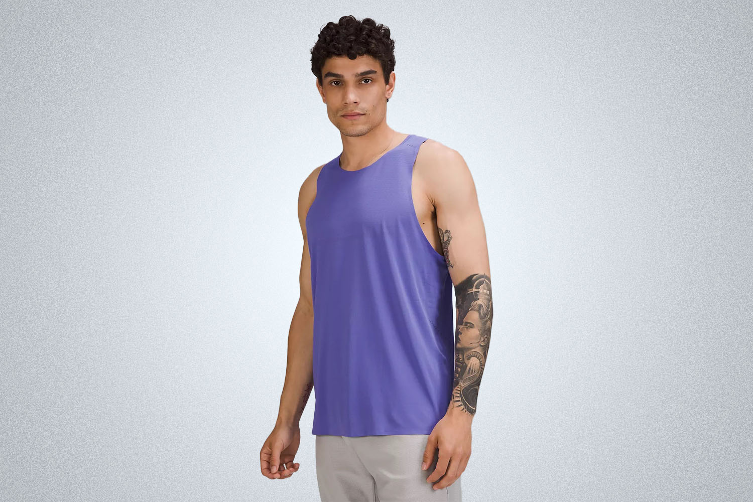 a pruple singlet from the lululemon we've made too much sale on a model on a grey background