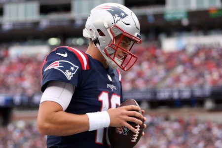Mac Jones of the Patriots looks down during a game against the Ravens.